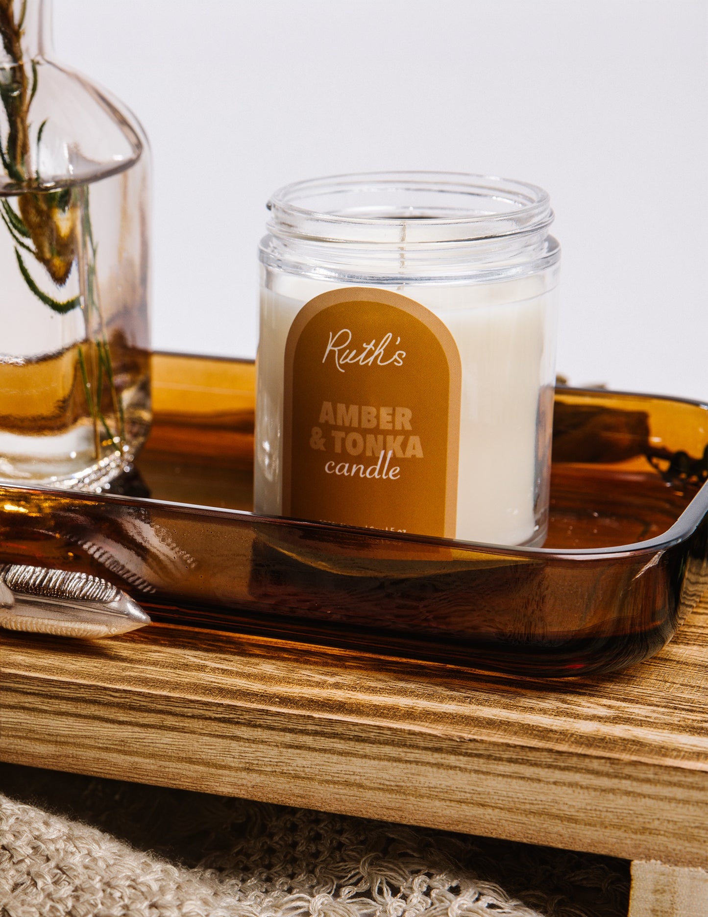 A Lifestyle Image of an Amber & Tonka candle